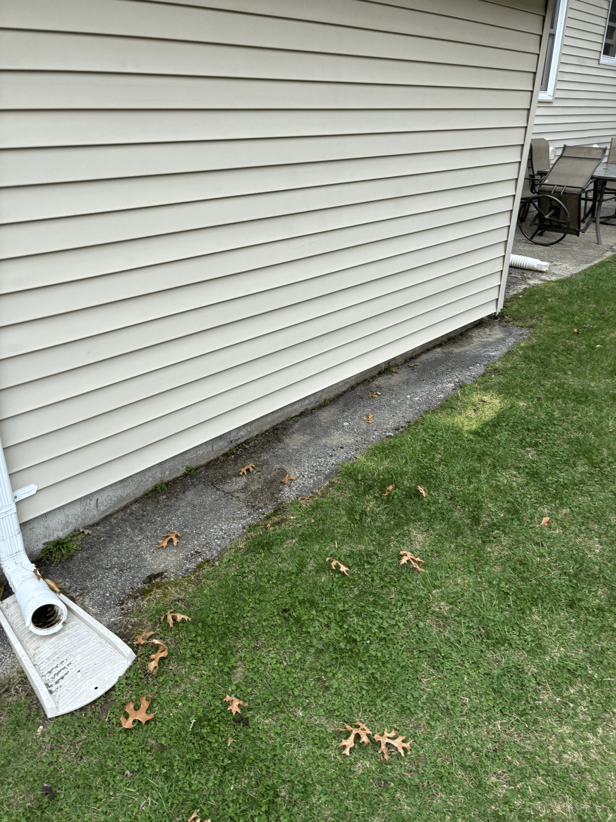 Cleared outdoor area beside a house after junk removal